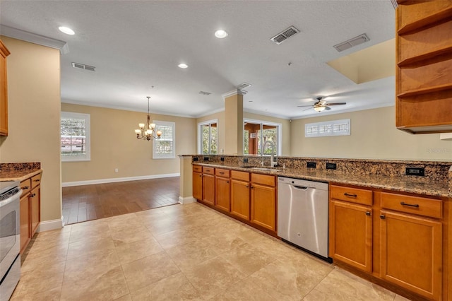 kitchen with a wealth of natural light, dark stone countertops, light hardwood / wood-style floors, and dishwasher