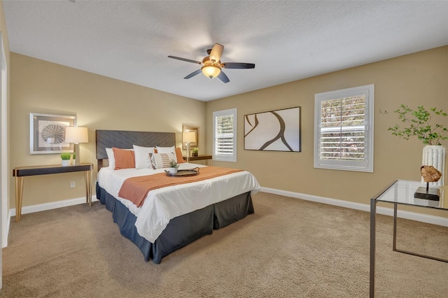 bedroom with a textured ceiling, carpet flooring, and ceiling fan