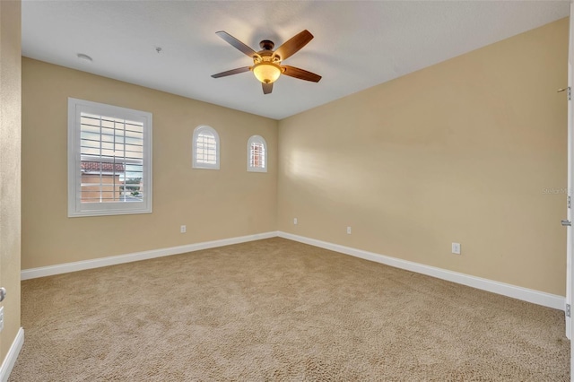 carpeted spare room with ceiling fan