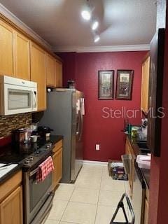 kitchen with light tile patterned floors, stainless steel electric stove, and crown molding