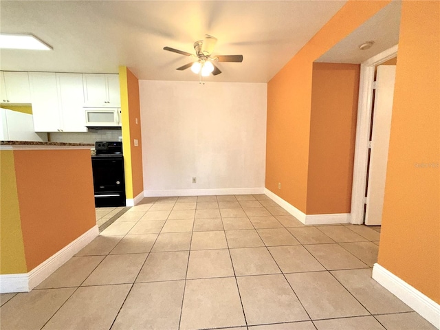 kitchen with black range with electric cooktop, light tile patterned floors, ceiling fan, and white cabinets