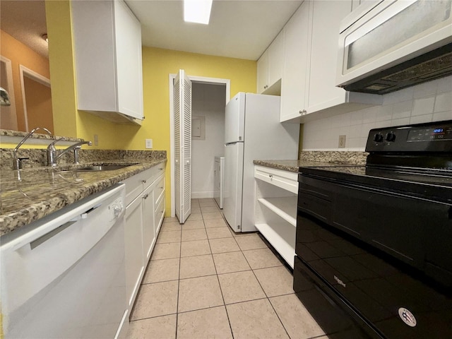 kitchen with light stone counters, white cabinets, sink, light tile patterned flooring, and white appliances