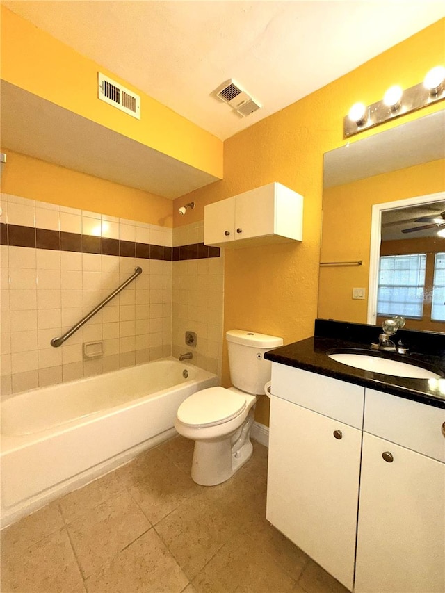 full bathroom with vanity, toilet, and tiled shower / bath