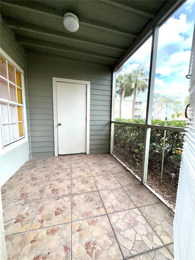 unfurnished sunroom featuring plenty of natural light