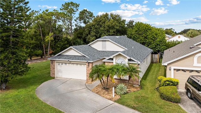 view of front of home with a front yard and a garage