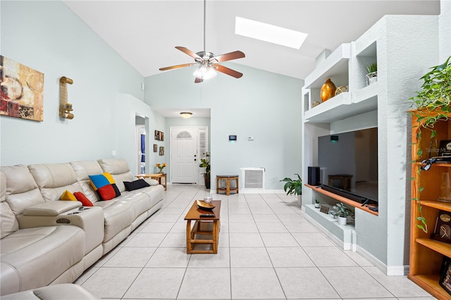 living room with ceiling fan, light tile patterned floors, high vaulted ceiling, and a skylight