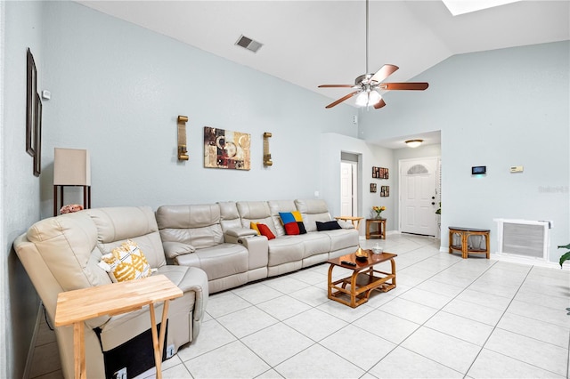 tiled living room featuring ceiling fan and high vaulted ceiling