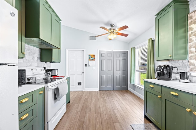 kitchen featuring white appliances, backsplash, green cabinetry, vaulted ceiling, and light hardwood / wood-style floors