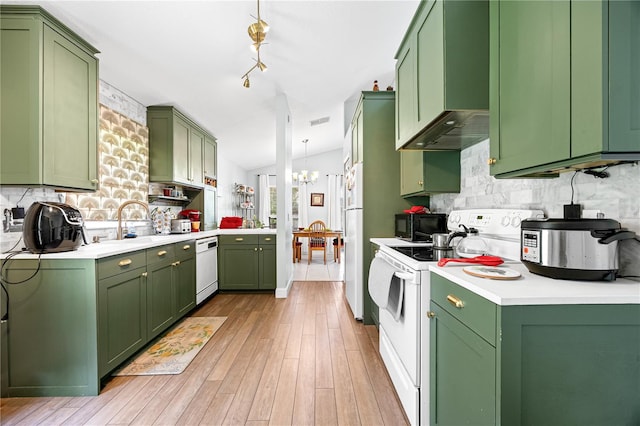 kitchen featuring lofted ceiling, white appliances, green cabinets, wall chimney range hood, and light wood-type flooring