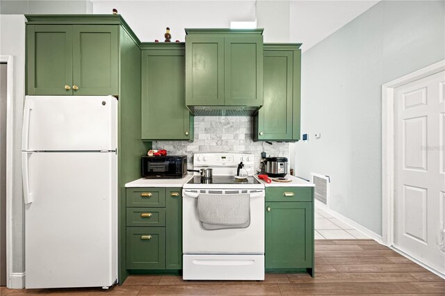 kitchen featuring white appliances, light hardwood / wood-style floors, and green cabinetry