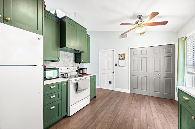 kitchen with white appliances, vaulted ceiling, ceiling fan, green cabinetry, and dark hardwood / wood-style floors