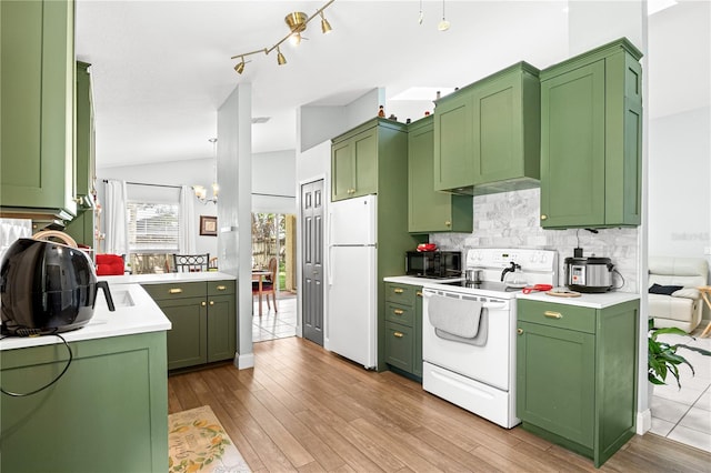 kitchen featuring lofted ceiling, light hardwood / wood-style floors, white appliances, and green cabinetry