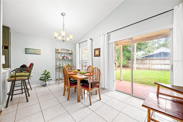 tiled dining space featuring a chandelier and lofted ceiling