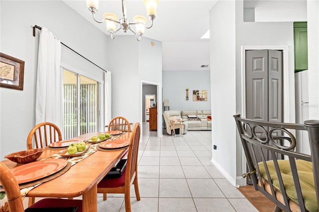 dining area featuring light tile patterned flooring and a chandelier