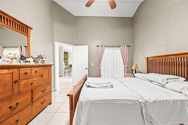 tiled bedroom featuring ceiling fan, high vaulted ceiling, and multiple windows