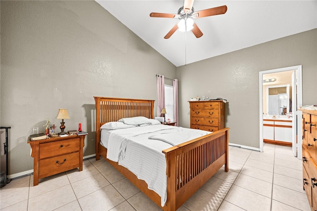 bedroom with ceiling fan, lofted ceiling, light tile patterned floors, and ensuite bath