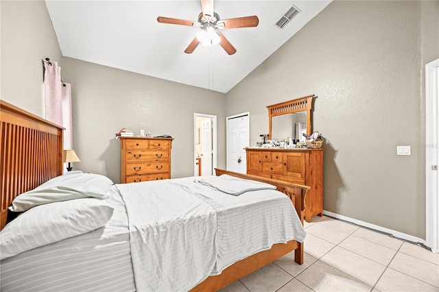 bedroom with light tile patterned floors, a closet, ceiling fan, and lofted ceiling