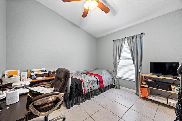 bedroom with ceiling fan, lofted ceiling, and light tile patterned flooring