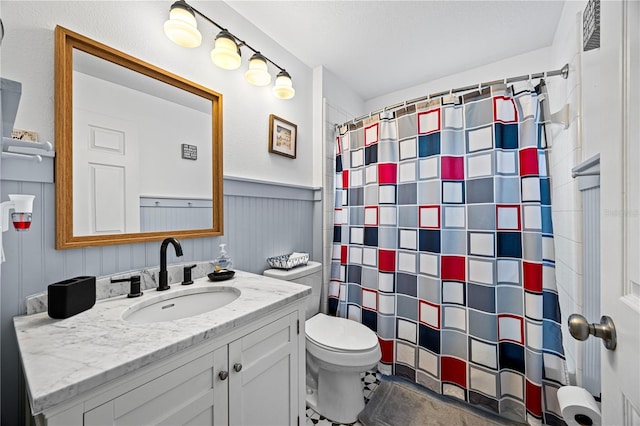 bathroom with vanity, toilet, and walk in shower