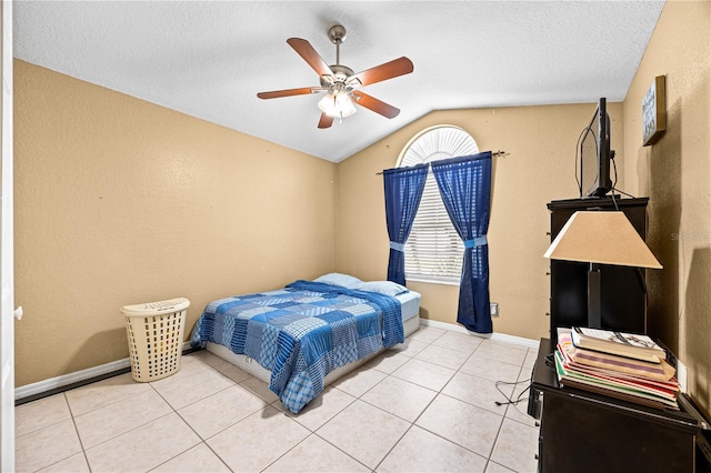 bedroom with light tile patterned floors, a textured ceiling, ceiling fan, and lofted ceiling