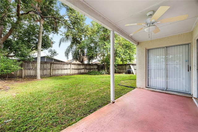 view of yard with ceiling fan and a patio area