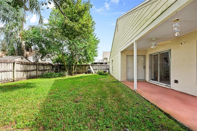 view of yard with a patio and ceiling fan