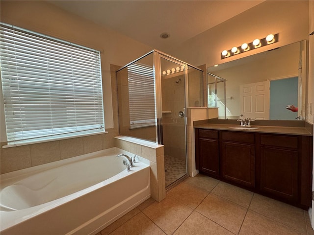 bathroom with vanity, shower with separate bathtub, and tile patterned floors