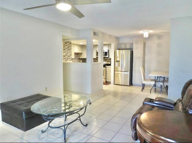 living room with ceiling fan and light tile patterned flooring