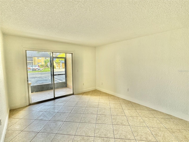 tiled spare room with a textured ceiling