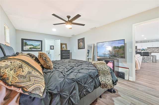 bedroom with ceiling fan and light hardwood / wood-style flooring