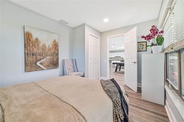 bedroom featuring hardwood / wood-style floors and crown molding