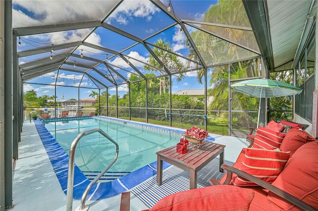 view of pool with a patio and glass enclosure