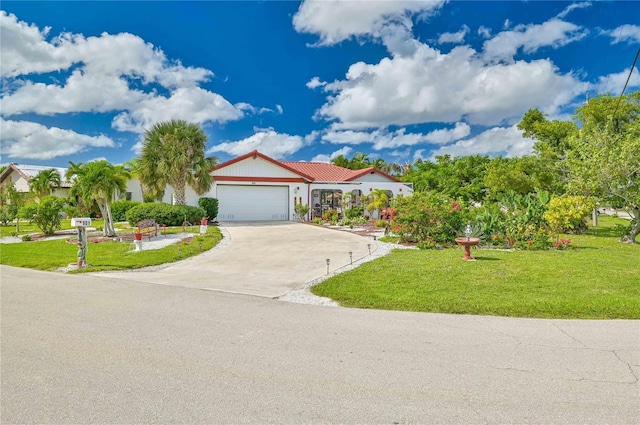 mediterranean / spanish-style house with a garage and a front yard