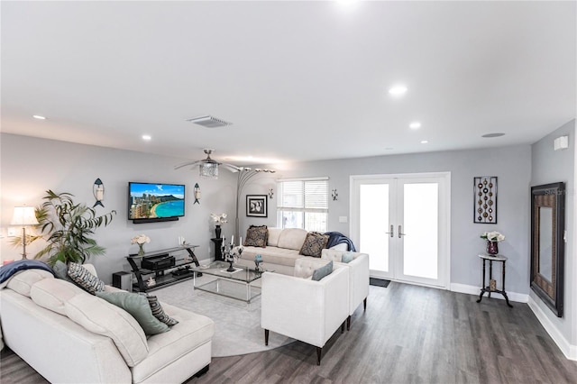 living room featuring wood-type flooring, french doors, and ceiling fan