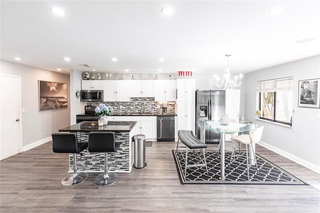 dining area featuring a chandelier, sink, and hardwood / wood-style floors