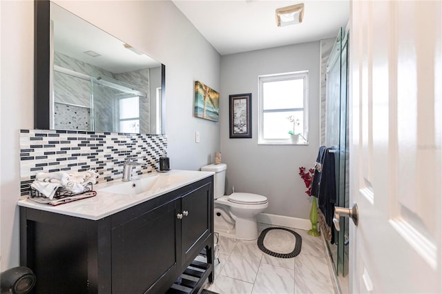 bathroom with tasteful backsplash, vanity, toilet, and walk in shower