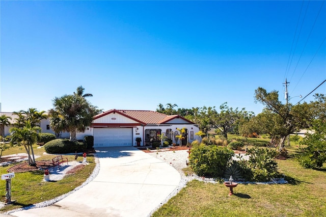 mediterranean / spanish house with a garage and a front lawn