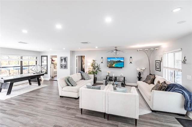 living room featuring hardwood / wood-style flooring, ceiling fan, and a healthy amount of sunlight