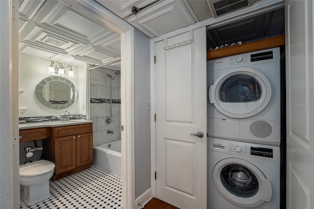 laundry room with stacked washer / drying machine and sink