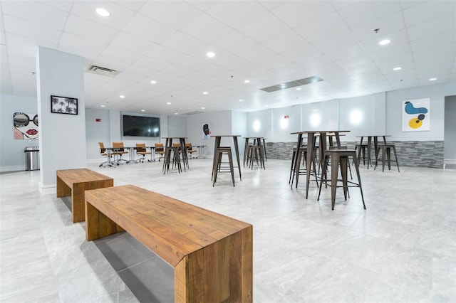 dining area with a paneled ceiling