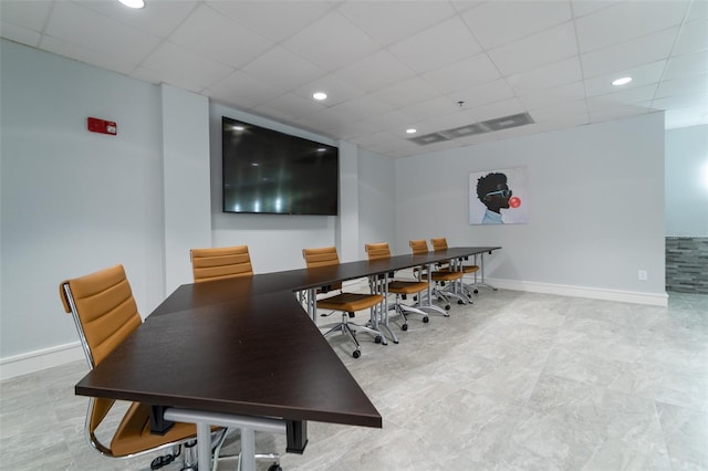 dining area featuring a drop ceiling and light tile patterned floors