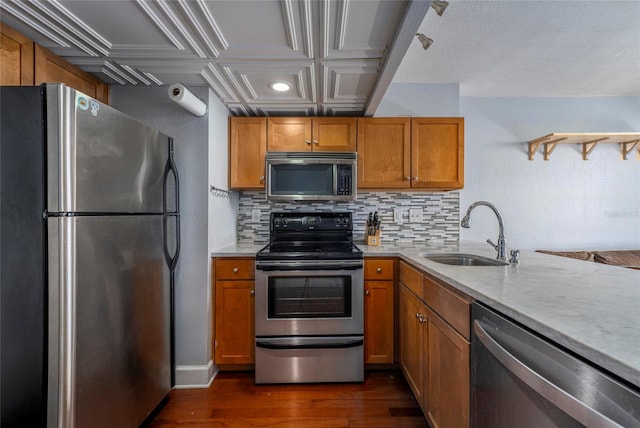 kitchen with backsplash, dark hardwood / wood-style floors, sink, and appliances with stainless steel finishes