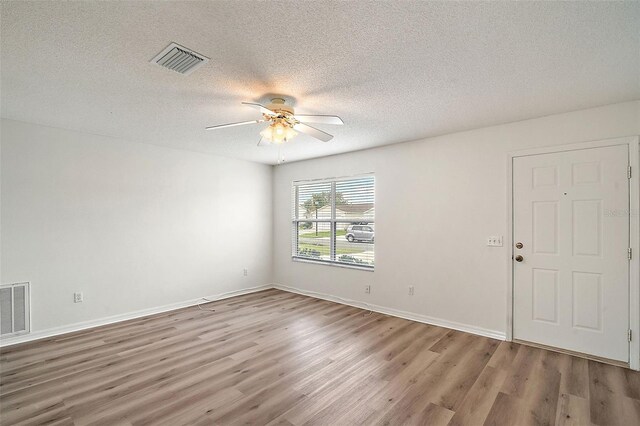2788 Privada Dr, The Villages, FL 32162 - spare room with a ceiling fan, wood finished floors, a textured ceiling, and baseboards