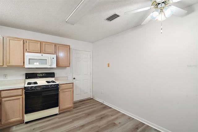 kitchen featuring light brown cabinetry, a textured ceiling, range, and light hardwood / wood-style flooring