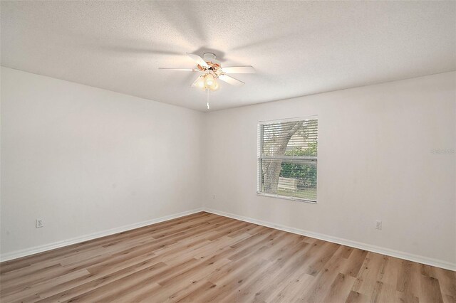 2788 Privada Dr, The Villages, FL 32162 - spare room with light wood-style floors, ceiling fan, baseboards, and a textured ceiling