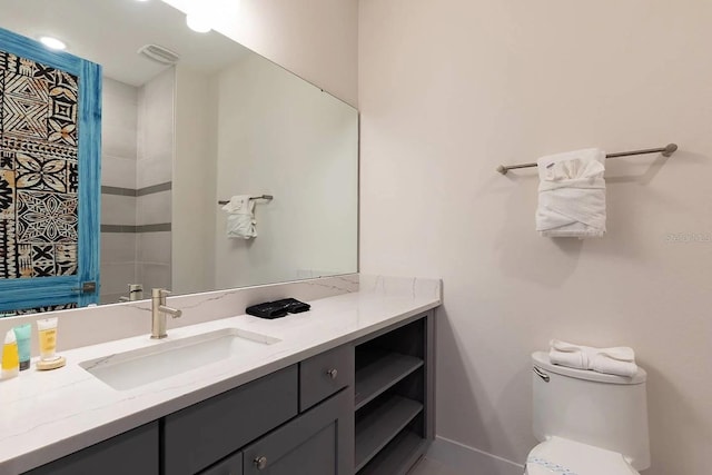 bathroom with toilet and vanity