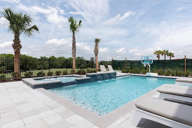 view of swimming pool featuring a patio, pool water feature, and an in ground hot tub