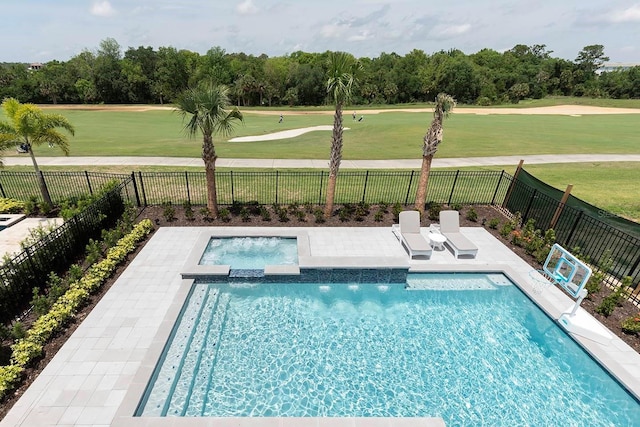 view of swimming pool featuring a yard, an in ground hot tub, and a patio area