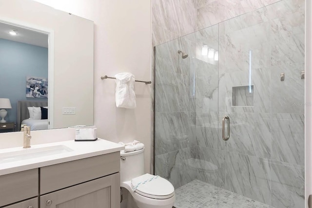 bathroom featuring vanity, toilet, and a shower with door