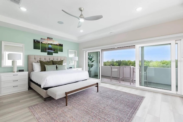 bedroom featuring light hardwood / wood-style floors, ceiling fan, and access to exterior